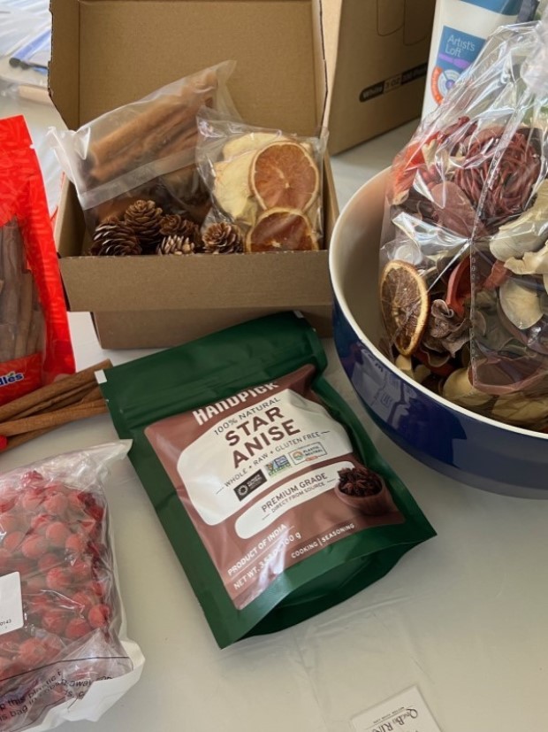 Assorted decorative items for aroma jars, including artificial fall leaves, dried orange slices, pine cones, and nuts.