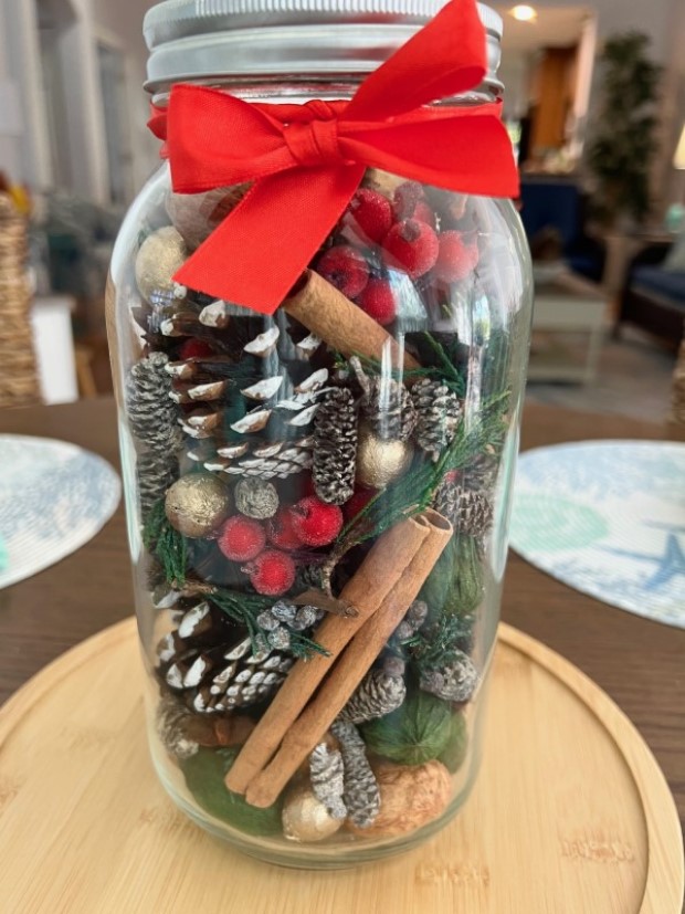 Final touch to the aroma jar: a bright red ribbon tied around the jar's neck.
