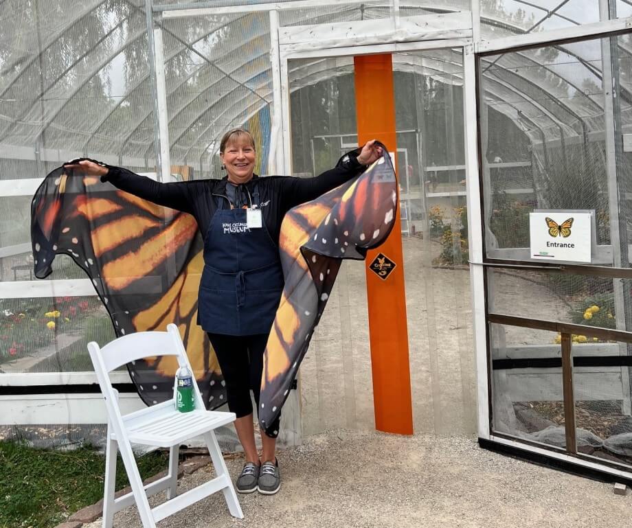 Me, outside the nature center, with large fabric monarch butterfly wings attached to my arms.